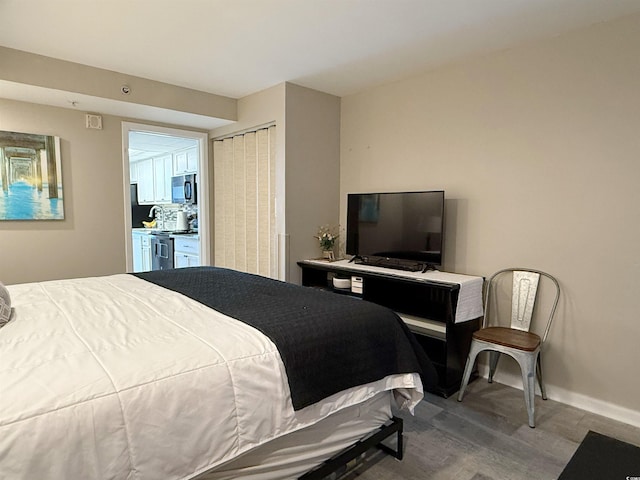 1501 S Ocean Blvd Unit 239, Myrtle Beach, SC 29577 - bedroom featuring wood finished floors, baseboards, and a closet