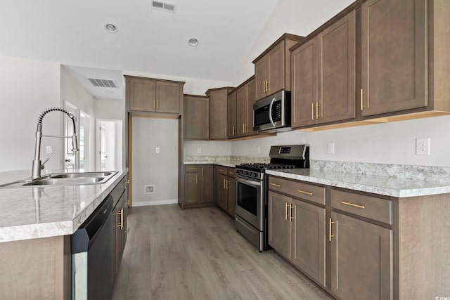 417 Grain Field Dr, Georgetown, SC 29440 - kitchen featuring appliances with stainless steel finishes, a sink, light wood-type flooring, light countertops, and lofted ceiling