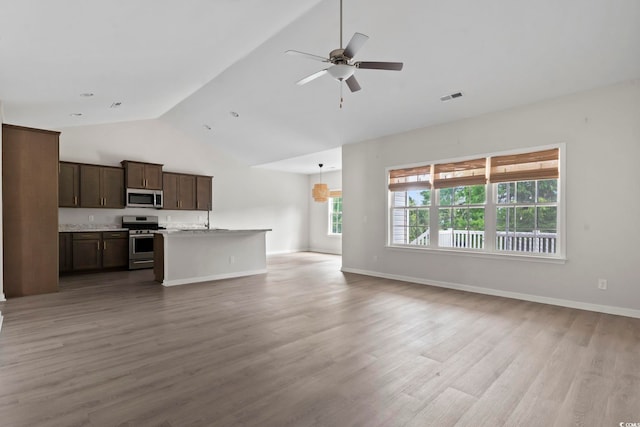 417 Grain Field Dr, Georgetown, SC 29440 - unfurnished living room with high vaulted ceiling, ceiling fan, light wood-style flooring, and baseboards