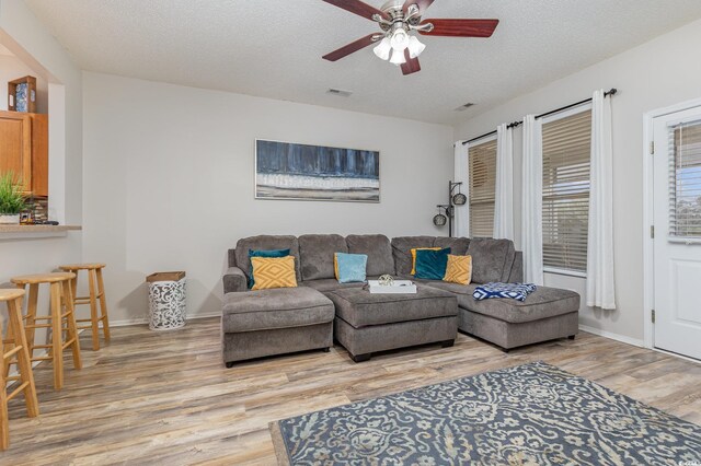 310 Kiskadee Loop Unit D, Conway, SC 29526 - living area featuring light wood finished floors, ceiling fan, and a textured ceiling