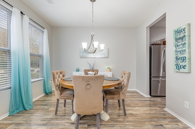 310 Kiskadee Loop Unit D, Conway, SC 29526 - dining area with a chandelier and wood finished floors