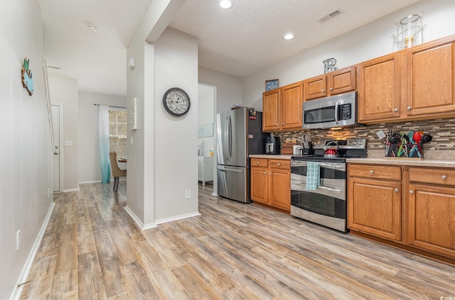 310 Kiskadee Loop Unit D, Conway, SC 29526 - kitchen featuring stainless steel appliances, light wood-style floors, tasteful backsplash, light countertops, and recessed lighting