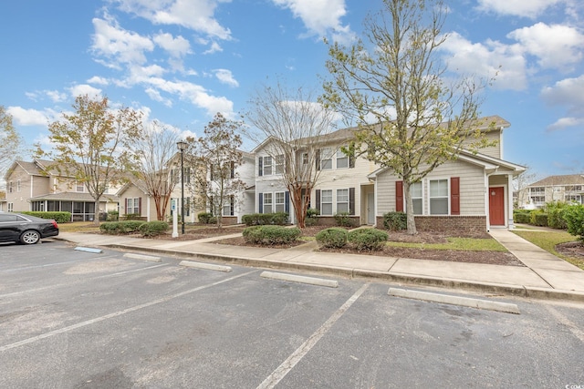 310 Kiskadee Loop Unit D, Conway, SC 29526 - view of property featuring uncovered parking, brick siding, and a residential view