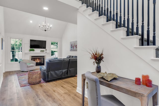 2150 N Berwick Dr, Myrtle Beach, SC 29575 - living area with high vaulted ceiling, wood finished floors, a chandelier, a glass covered fireplace, and recessed lighting