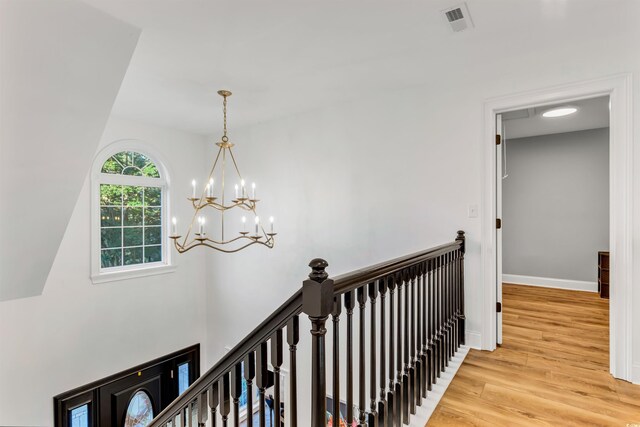 2150 N Berwick Dr, Myrtle Beach, SC 29575 - corridor featuring wood finished floors, a chandelier, baseboards, and an upstairs landing