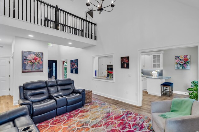 2150 N Berwick Dr, Myrtle Beach, SC 29575 - living area with a towering ceiling, wood finished floors, baseboards, and a chandelier