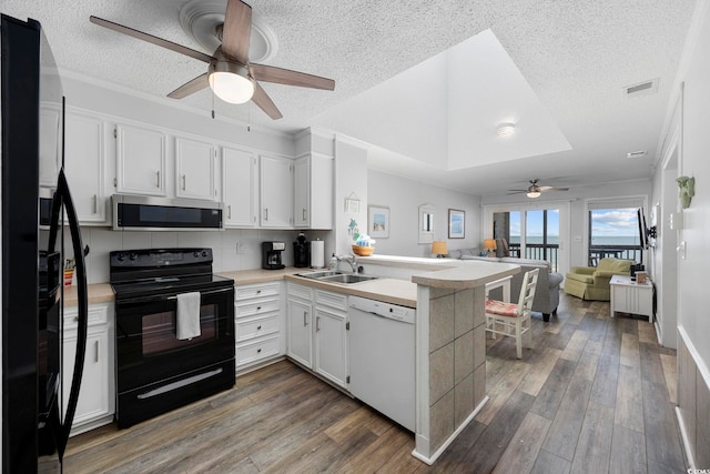 208 Ocean Blvd N Unit 324, North Myrtle Beach, SC 29582 - kitchen with black appliances, a ceiling fan, a peninsula, open floor plan, and a sink