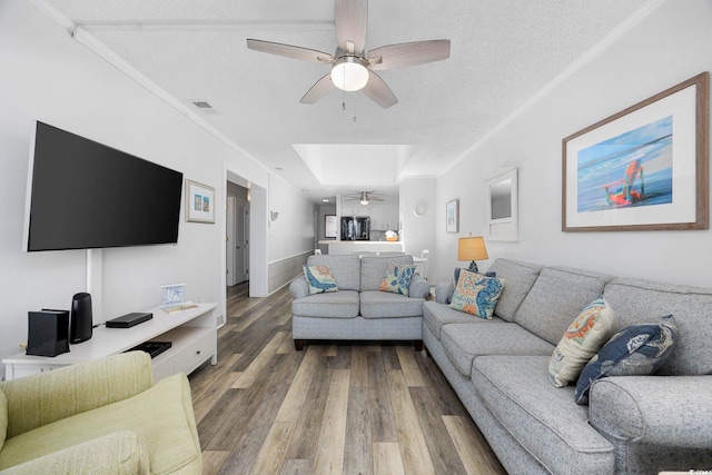 208 Ocean Blvd N Unit 324, North Myrtle Beach, SC 29582 - living room featuring ceiling fan, wood finished floors, a textured ceiling, and crown molding