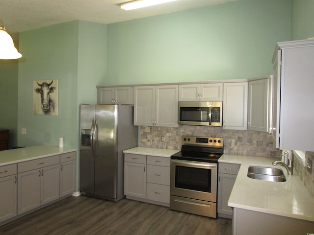 811 Rogers Rd, Myrtle Beach, SC 29577 - kitchen featuring stainless steel appliances, a sink, backsplash, dark wood finished floors, and a towering ceiling