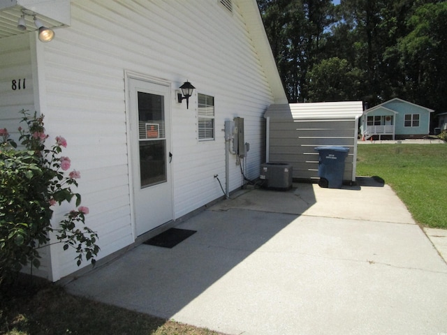 811 Rogers Rd, Myrtle Beach, SC 29577 - view of property exterior featuring a patio, cooling unit, and a lawn