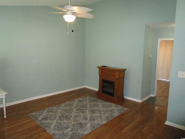 811 Rogers Rd, Myrtle Beach, SC 29577 - unfurnished living room with dark wood finished floors, ceiling fan, a glass covered fireplace, and baseboards