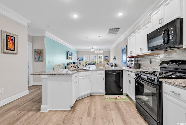 232 Je Edward Dr Unit 19, Myrtle Beach, SC 29588 - kitchen featuring black appliances, a peninsula, a sink, white cabinetry, and recessed lighting