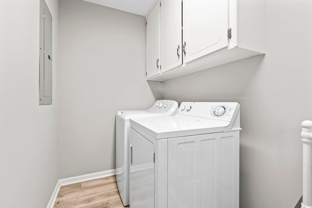 204 Elm St, Johnsonville, SC 29555 - laundry room featuring washing machine and dryer, cabinet space, light wood finished floors, baseboards, and electric panel