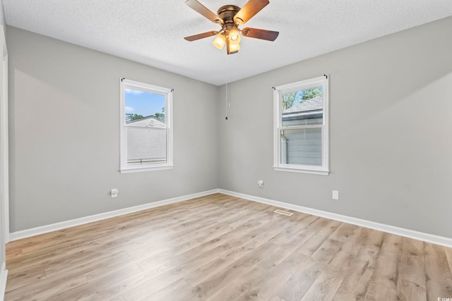 204 Elm St, Johnsonville, SC 29555 - spare room featuring light wood-style floors, a textured ceiling, baseboards, and ceiling fan