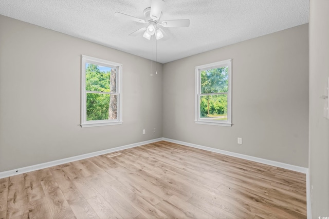 204 Elm St, Johnsonville, SC 29555 - spare room with a textured ceiling, light wood-type flooring, ceiling fan, and baseboards