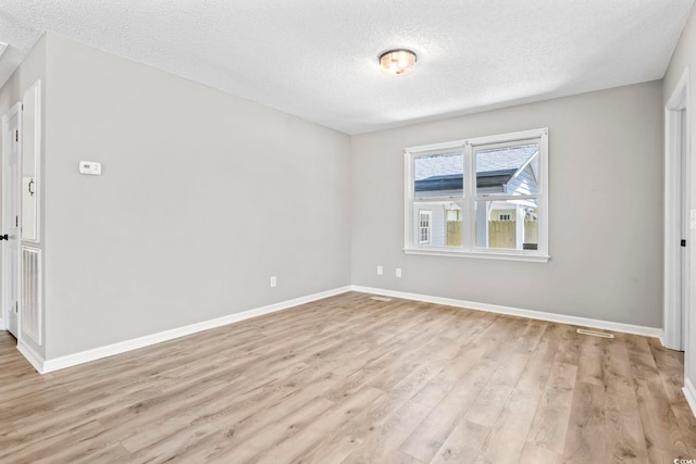 204 Elm St, Johnsonville, SC 29555 - unfurnished room featuring a textured ceiling, light wood-style flooring, and baseboards