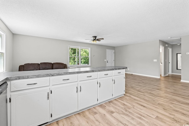 204 Elm St, Johnsonville, SC 29555 - kitchen with a ceiling fan, open floor plan, a textured ceiling, light wood-type flooring, and white cabinetry