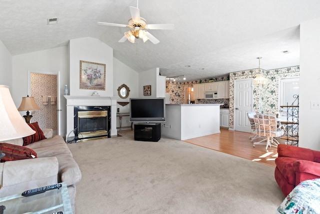 4012 Grousewood Dr, Myrtle Beach, SC 29588 - living area with light carpet, ceiling fan, a fireplace, and lofted ceiling