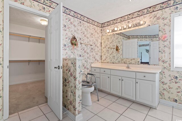 4012 Grousewood Dr, Myrtle Beach, SC 29588 - bathroom with wallpapered walls, vanity, a textured ceiling, tile patterned flooring, and baseboards