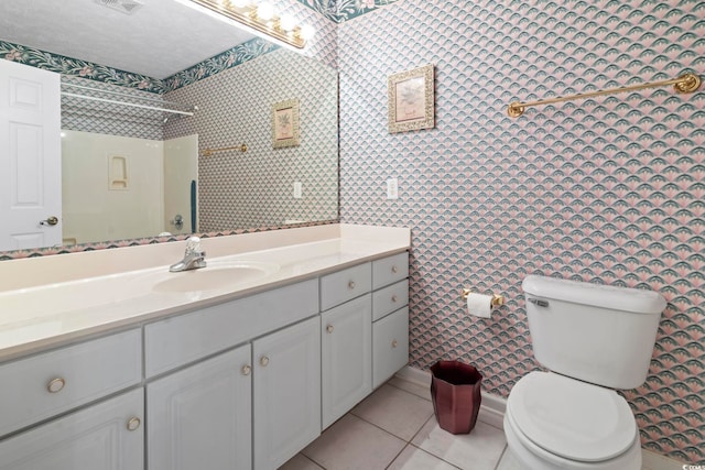 4012 Grousewood Dr, Myrtle Beach, SC 29588 - full bathroom with vanity, toilet, tile patterned floors, wallpapered walls, and a shower