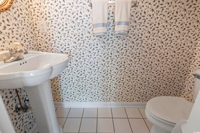 4012 Grousewood Dr, Myrtle Beach, SC 29588 - bathroom with wallpapered walls, baseboards, tile patterned floors, toilet, and a sink