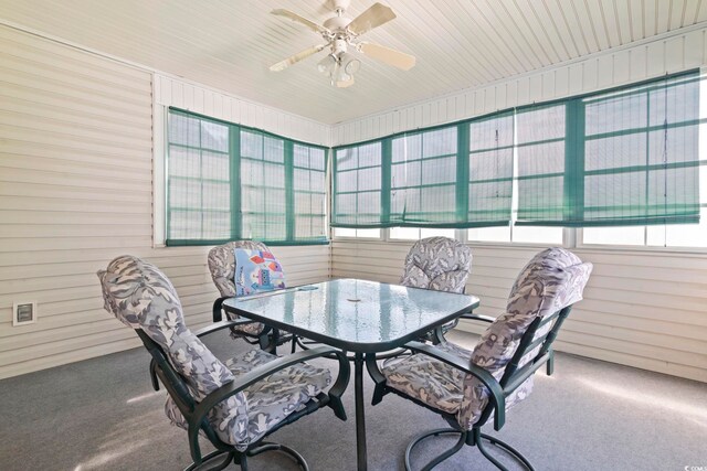4012 Grousewood Dr, Myrtle Beach, SC 29588 - carpeted dining room with healthy amount of natural light, a ceiling fan, and wooden walls