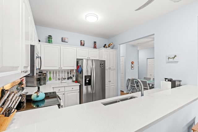 3104 Sweetwater Blvd Unit 3104, Murrells Inlet, SC 29576 - kitchen with appliances with stainless steel finishes, a sink, light countertops, backsplash, and white cabinets