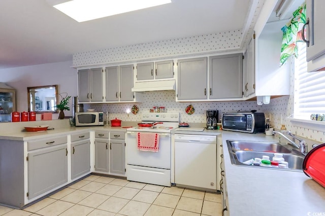 1437 Baldwin Ct Unit 1437, Little River, SC 29566 - kitchen with white appliances, a peninsula, light countertops, and light tile patterned floors