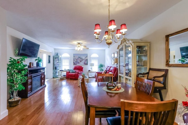 1437 Baldwin Ct Unit 1437, Little River, SC 29566 - dining space featuring a glass covered fireplace, wood finished floors, ceiling fan, and a chandelier