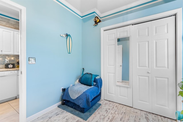 230 Addison Cottage Way, Murrells Inlet, SC 29576 - bedroom with crown molding, a closet, baseboards, and light wood-style flooring