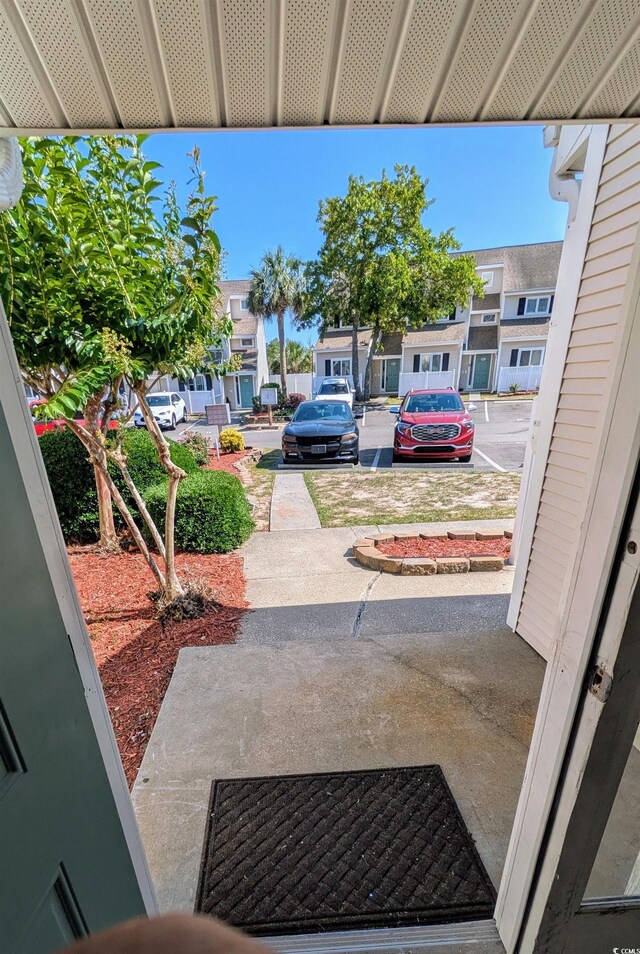 600 Deer Creek Rd Unit D, Surfside Beach, SC 29575 - kitchen featuring white appliances, a kitchen island, a sink, light carpet, and a ceiling fan