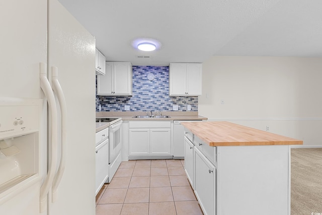 600 Deer Creek Rd Unit D, Surfside Beach, SC 29575 - kitchen featuring white appliances, butcher block counters, tasteful backsplash, a center island, and a sink