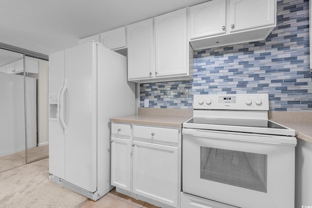 600 Deer Creek Rd Unit D, Surfside Beach, SC 29575 - kitchen featuring white appliances, white cabinetry, light countertops, tasteful backsplash, and under cabinet range hood