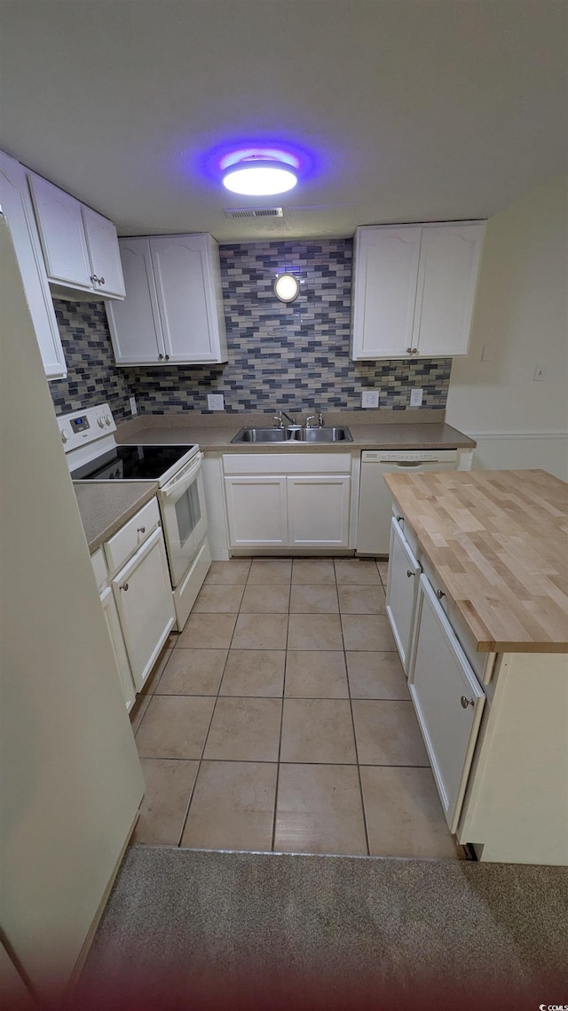 600 Deer Creek Rd Unit D, Surfside Beach, SC 29575 - kitchen featuring white appliances, wood counters, light tile patterned flooring, decorative backsplash, and white cabinets