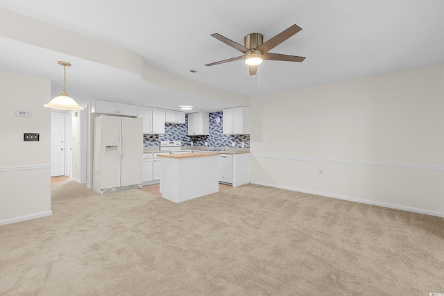 600 Deer Creek Rd Unit D, Surfside Beach, SC 29575 - kitchen with white appliances, a center island, light carpet, and a ceiling fan