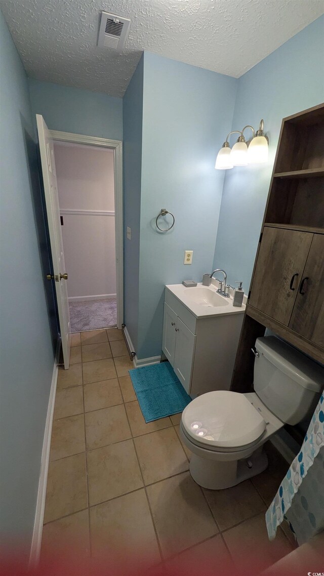 600 Deer Creek Rd Unit D, Surfside Beach, SC 29575 - bathroom featuring toilet, vanity, tile patterned flooring, a textured ceiling, and baseboards