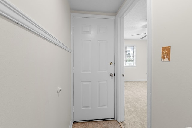 600 Deer Creek Rd Unit D, Surfside Beach, SC 29575 - doorway to outside with baseboards, a textured ceiling, and light tile patterned floors