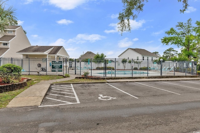 600 Deer Creek Rd Unit D, Surfside Beach, SC 29575 - uncovered parking lot featuring a community pool