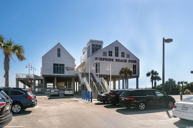 600 Deer Creek Rd Unit D, Surfside Beach, SC 29575 - view of building exterior featuring uncovered parking and stairway