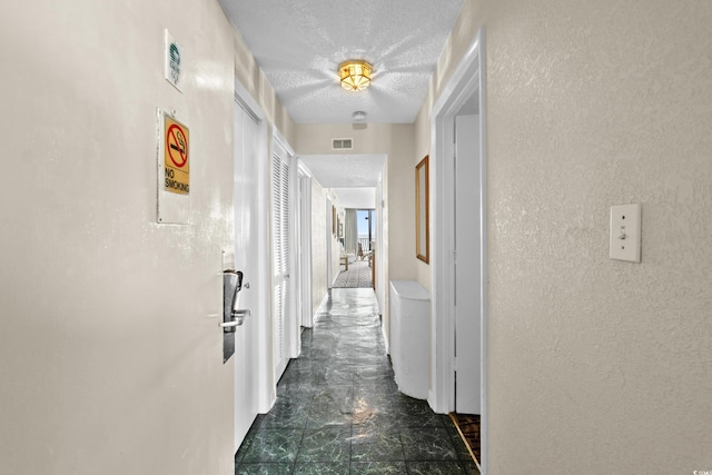 2500 N Ocean Blvd Unit 601, Myrtle Beach, SC 29577 - hallway featuring a textured wall and a textured ceiling