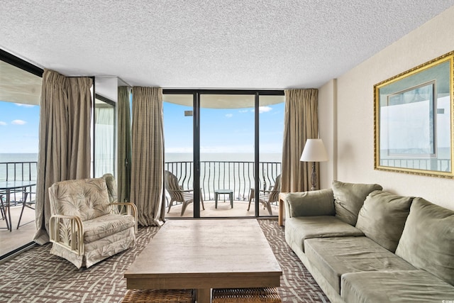 2500 N Ocean Blvd Unit 601, Myrtle Beach, SC 29577 - living room featuring view of water and beach, a textured ceiling, floor to ceiling windows, and plenty of natural light