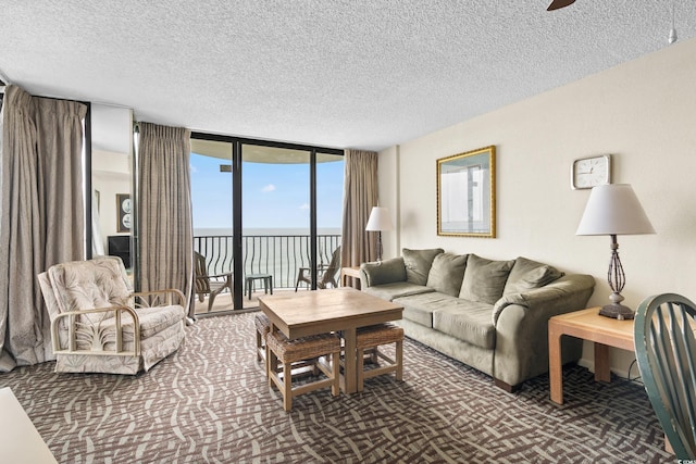 2500 N Ocean Blvd Unit 601, Myrtle Beach, SC 29577 - carpeted living room with a water view, a textured ceiling, floor to ceiling windows, and a ceiling fan