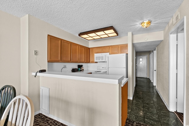 2500 N Ocean Blvd Unit 601, Myrtle Beach, SC 29577 - kitchen featuring white appliances, a peninsula, a textured ceiling, light countertops, and baseboards