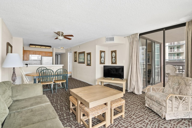 2500 N Ocean Blvd Unit 601, Myrtle Beach, SC 29577 - carpeted living area with a ceiling fan and a textured ceiling
