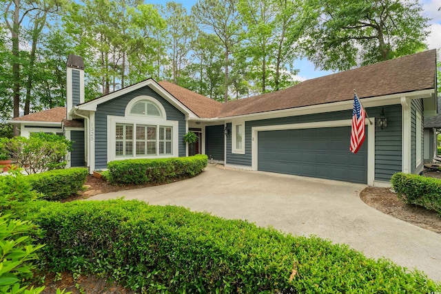 1325 Clipper Dr, North Myrtle Beach, SC 29582 - ranch-style house featuring a garage, concrete driveway, a chimney, and roof with shingles