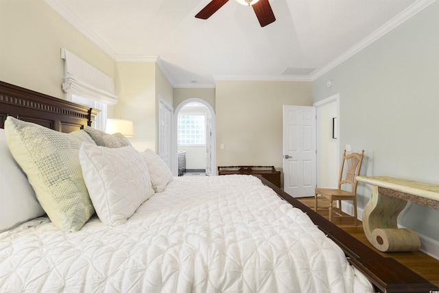1325 Clipper Dr, North Myrtle Beach, SC 29582 - bedroom with wood finished floors, ornamental molding, baseboards, arched walkways, and a ceiling fan