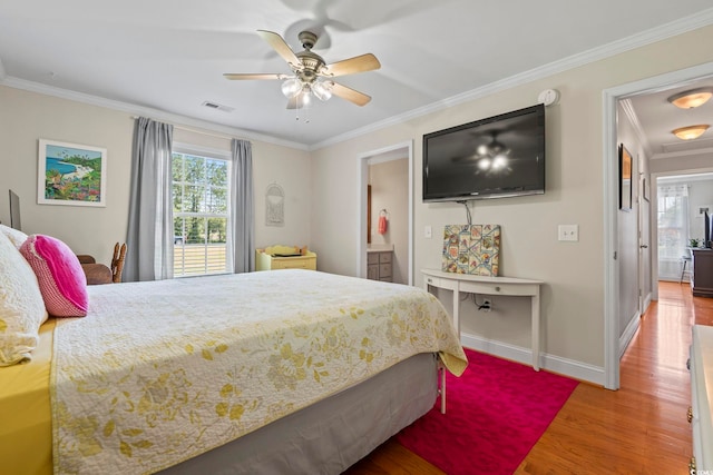 1609 Bridgebrook Ln, Conway, SC 29527 - bedroom featuring multiple windows, wood finished floors, ornamental molding, baseboards, and ensuite bath