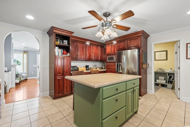 1609 Bridgebrook Ln, Conway, SC 29527 - kitchen featuring white microwave, stainless steel fridge, arched walkways, green cabinetry, and light tile patterned flooring
