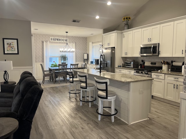 2529 Suzanne Dr, Conway, SC 29526 - kitchen featuring stainless steel appliances, a chandelier, an island with sink, white cabinets, and wallpapered walls