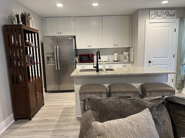 2529 Suzanne Dr, Conway, SC 29526 - kitchen with stainless steel fridge, light wood-style flooring, a sink, recessed lighting, and backsplash